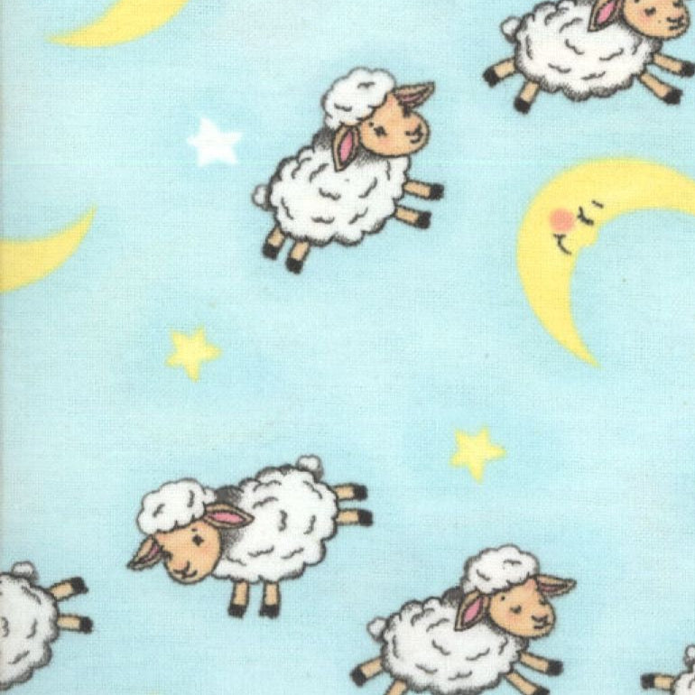 Flannel with cartoon sheep, moons, and stars on a blue background